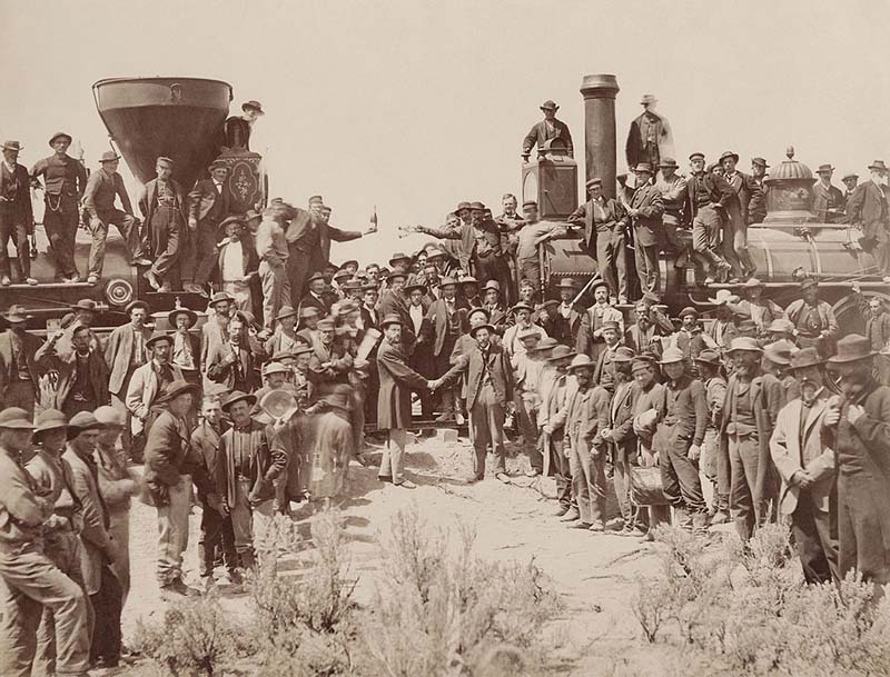 "East and West Shaking hands at the laying of last rail Union Pacific Railroad - Restoration" by Andrew J. Russell - Yale University Libraries. Licensed under Public Domain via Commons - https://commons.wikimedia.org/wiki/File:East_and_West_Shaking_hands_at_the_laying_of_last_rail_Union_Pacific_Railroad_-_Restoration.jpg#/media/File:East_and_West_Shaking_hands_at_the_laying_of_last_rail_Union_Pacific_Railroad_-_Restoration.jpg